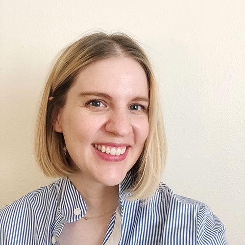 Photograph of a white woman with short blonde hair smiling to camera