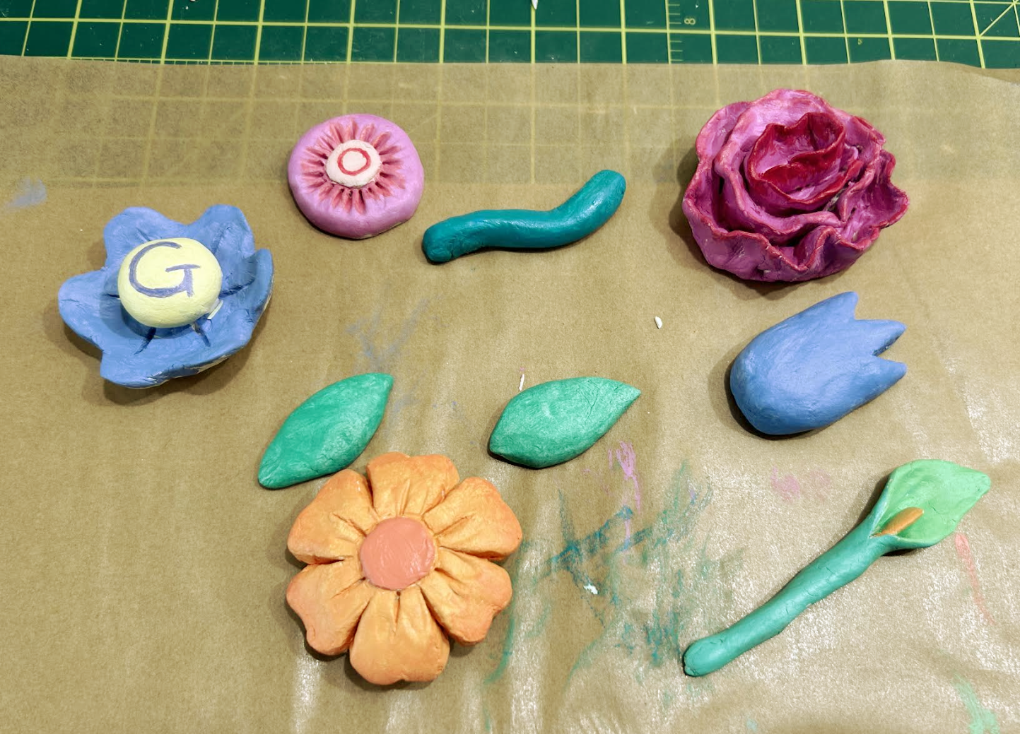 Photograph of five painted clay flowers 