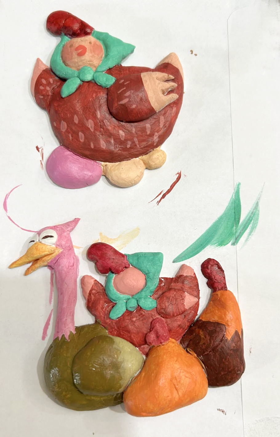 Photograph of partially painted clay showing mother hen and her children