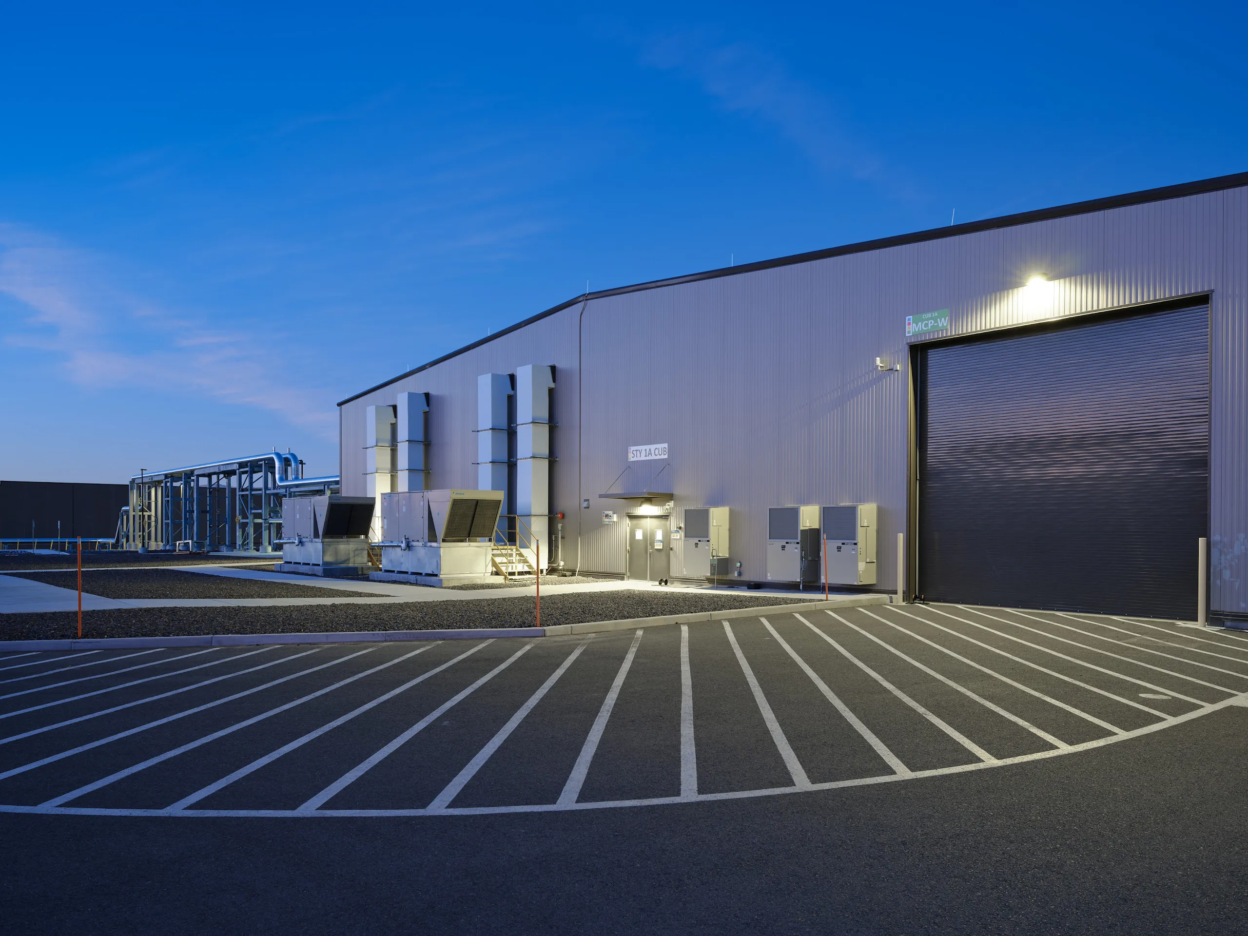 An exterior photograph of a driveway leading up to a Google gCUB mechanics building.