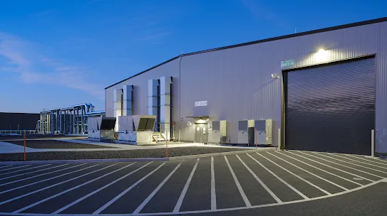 An exterior photograph of a driveway leading up to a Google gCUB mechanics building.