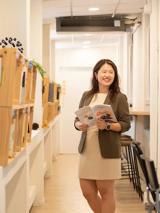 Rachel Huang from Junyi Academy stands and reads a journal in Taipei Taiwan