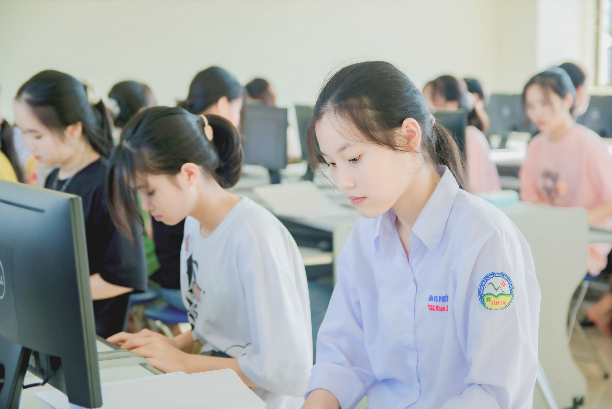 A person in a white shirt sitting beside another person also wearing white