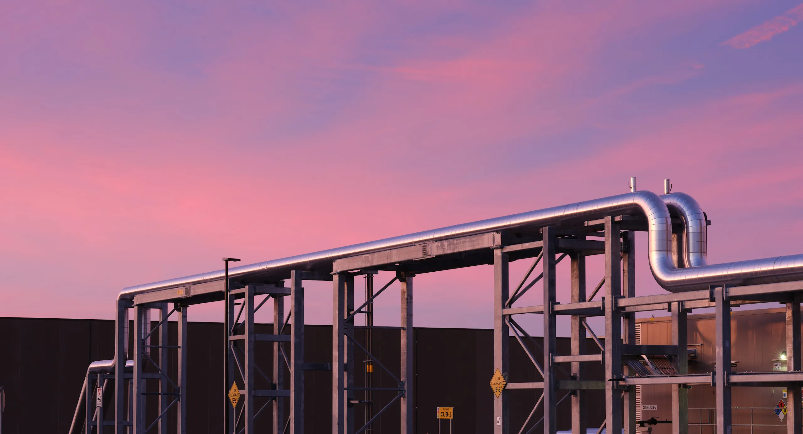 An exterior photo of cooling pipes during a Nevada sunset at Google's Storey County data centers.