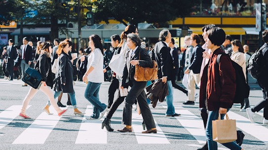 People crossing a bustling city street.