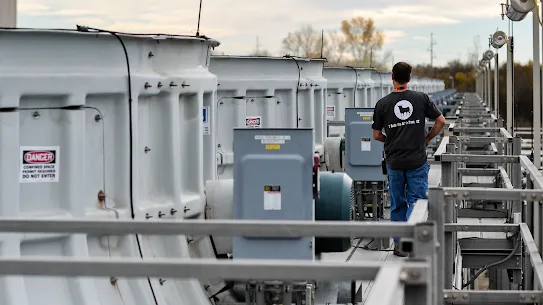 Worker inspecting Mayes County cooling towers