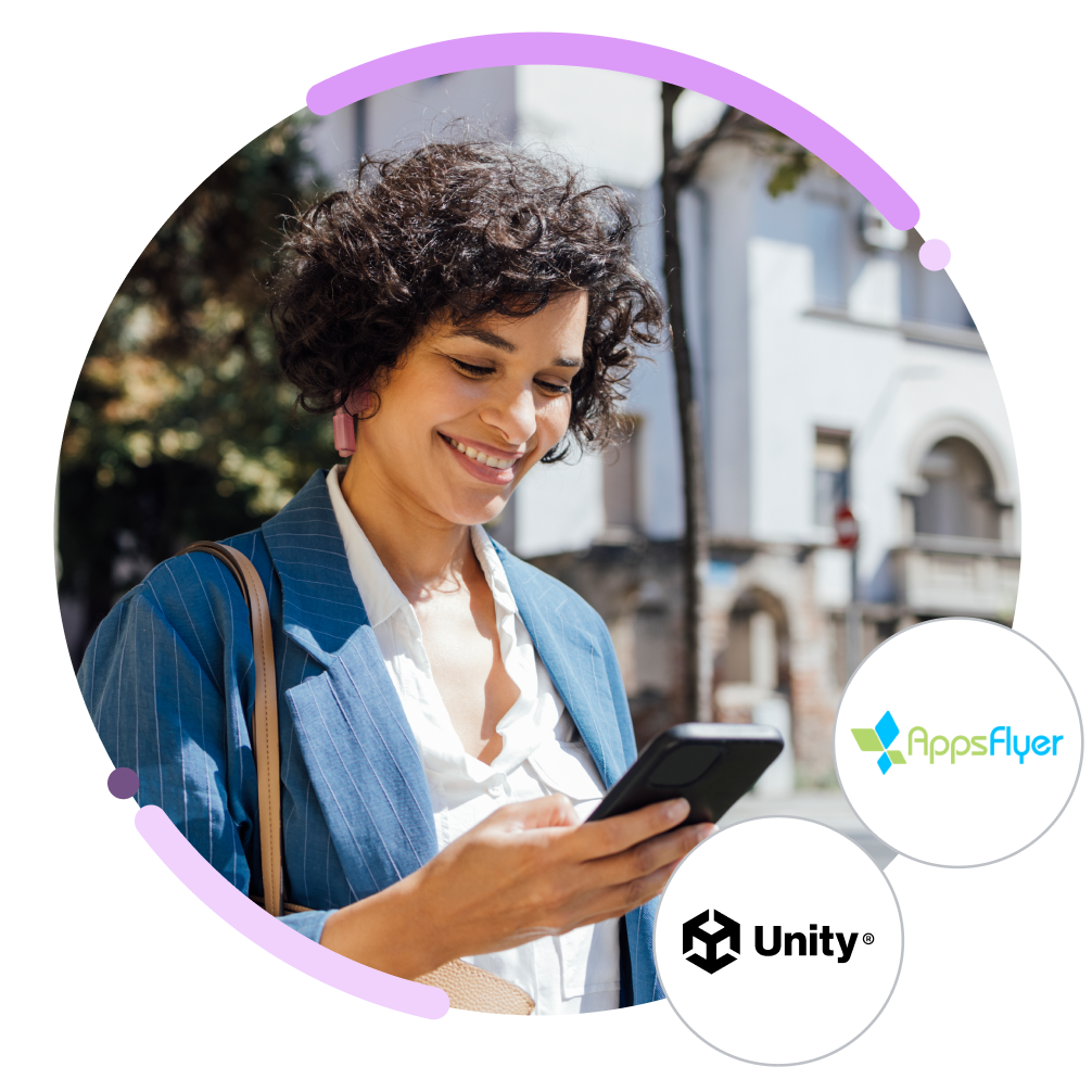 A photo of a woman using her phone, with the Appsflyer and Unity logos.