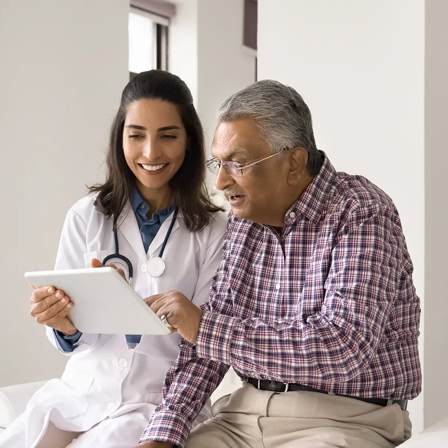 A doctor shares information with an elderly patient