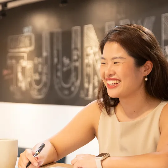 Rachel Huang from Junyi Academy looks up from her work and smiles in Taipei Taiwan