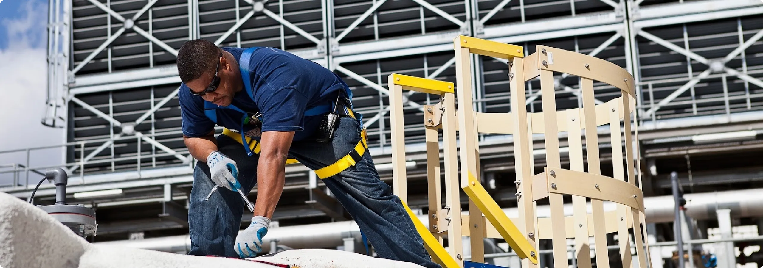 A Google facilities technician checks the piping infrastructure on the roof of a Google data center.