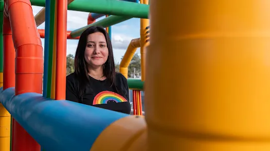 Googler Kareen Elizabeth Araneda stands among colorful pipes at the Quilicura Chile data center