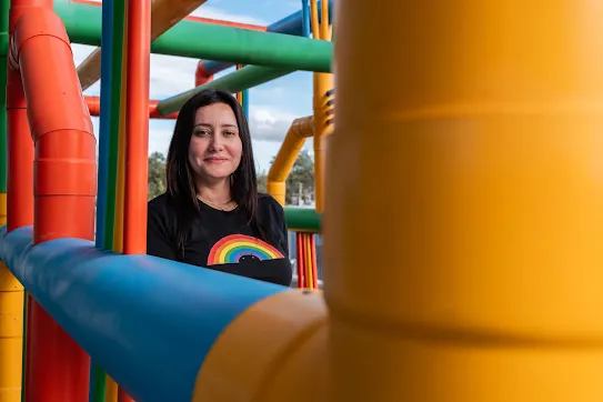 Googler Kareen Elizabeth Araneda stands among colorful pipes at the Quilicura Chile data center