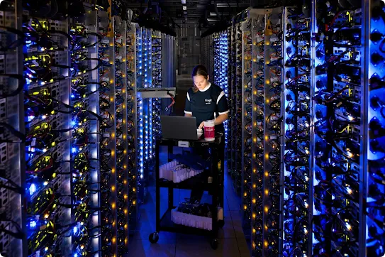 A technician troubleshoots an issue between a row of servers in our The Dalles, Oregon, data center.