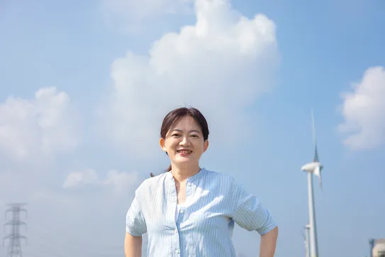 Googler Melody Chang stands in front of windmill in Changhua County Taiwan