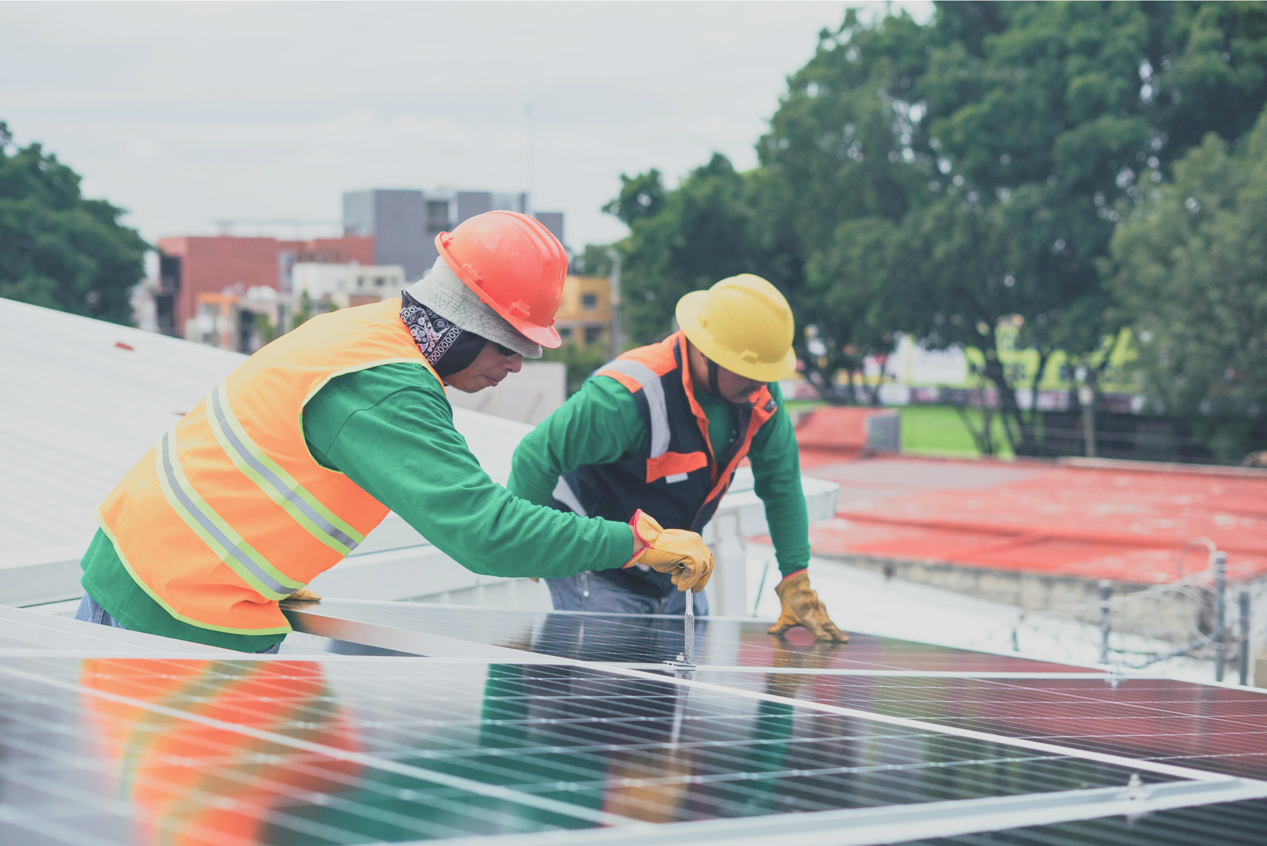 Two people working together installing solar panels