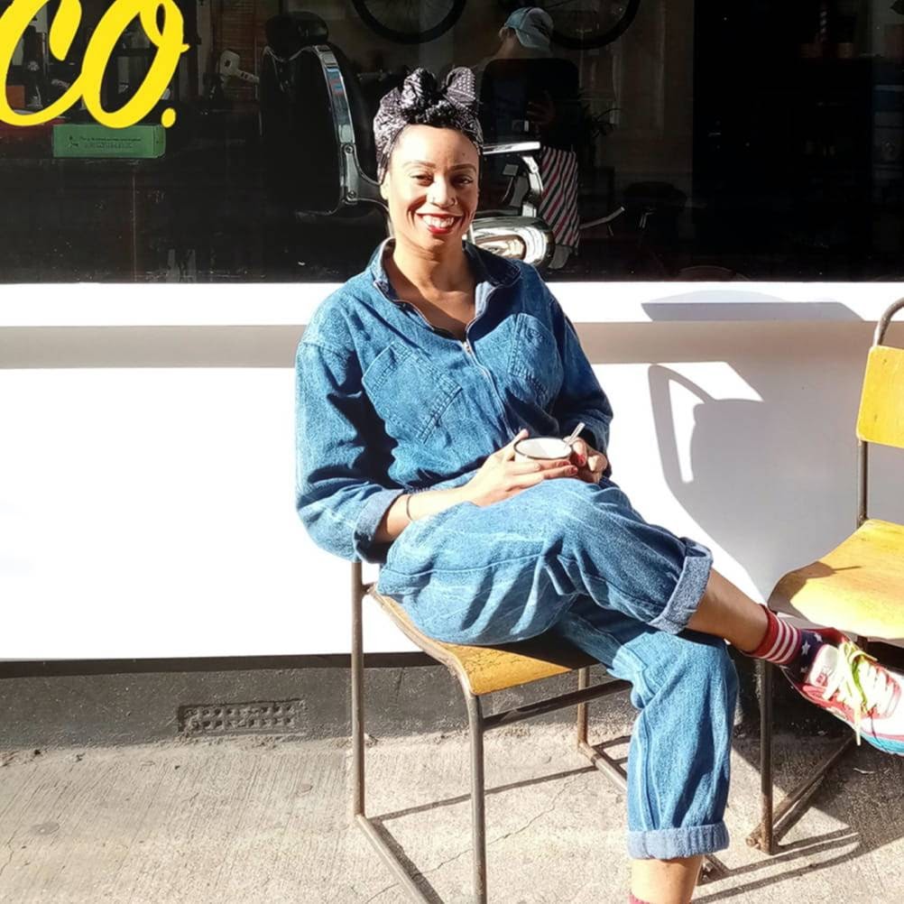 Smiling woman sitting on a chair.