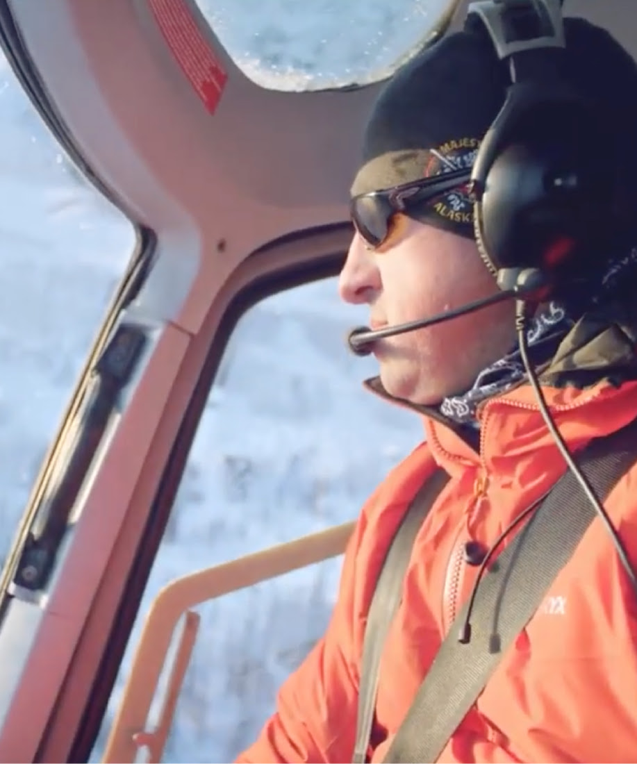 A pilot from Majestic Heli Ski flying a helicopter. 