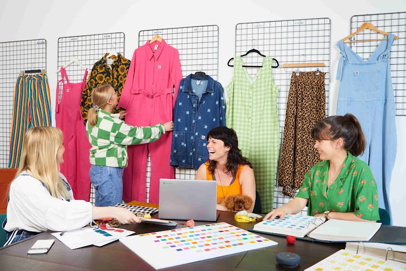 Lucy & Yak employees taking pictures of their stock for use on social media