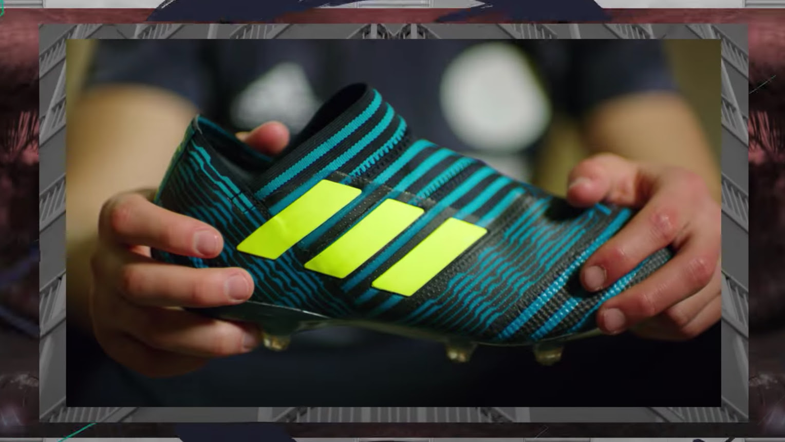 A close-up of hands holding one colorful adidas shoe