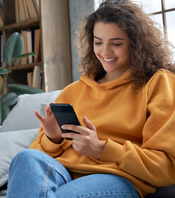 Close up of someone using their smartphone in their left hand