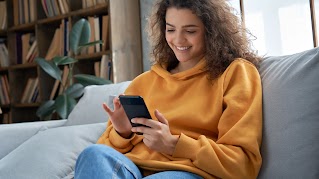 Close up of someone using their smartphone in their left hand