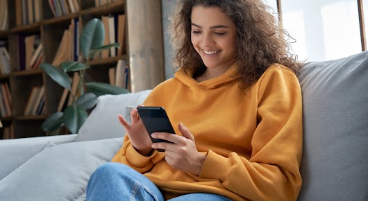 Close up of someone using their smartphone in their left hand