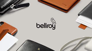 Close-up of an array of Bellroy accessories with the Bellroy logo at the centre.