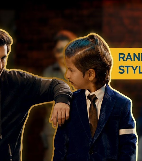 Ranbir talking to a young boy in a suit with the words Ranbir's killer style secret in the background