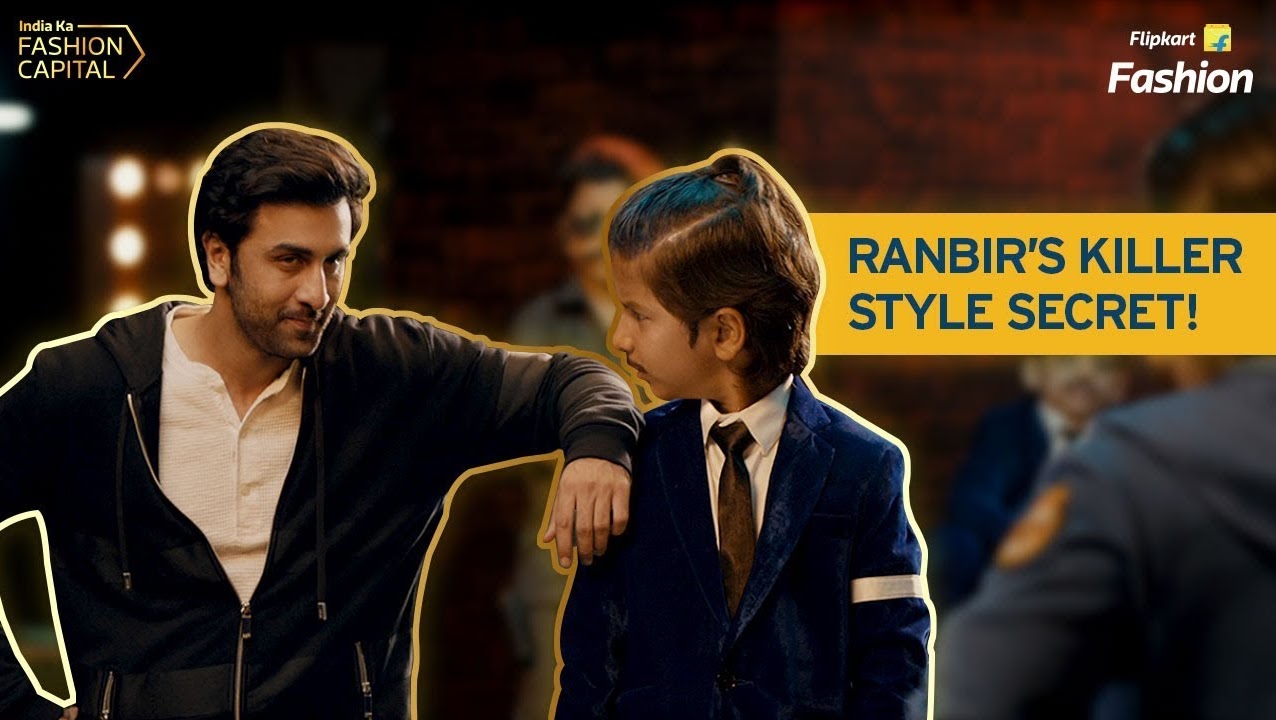 Ranbir talking to a young boy in a suit with the words Ranbir's killer style secret in the background