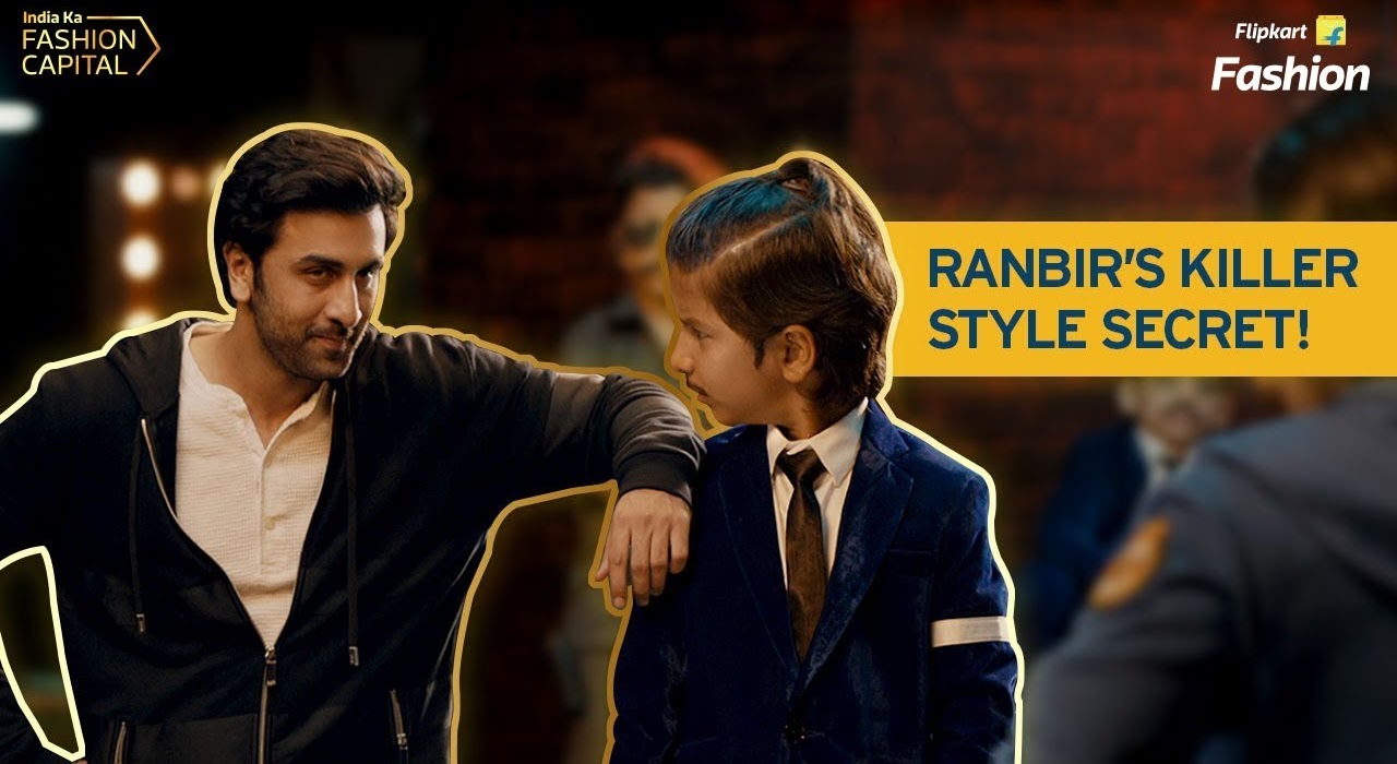 Ranbir talking to a young boy in a suit with the words Ranbir's killer style secret in the background