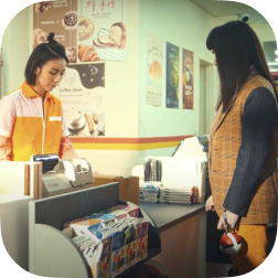 We see the preview image to a video of a woman having her items rung up at a checkout counter. 