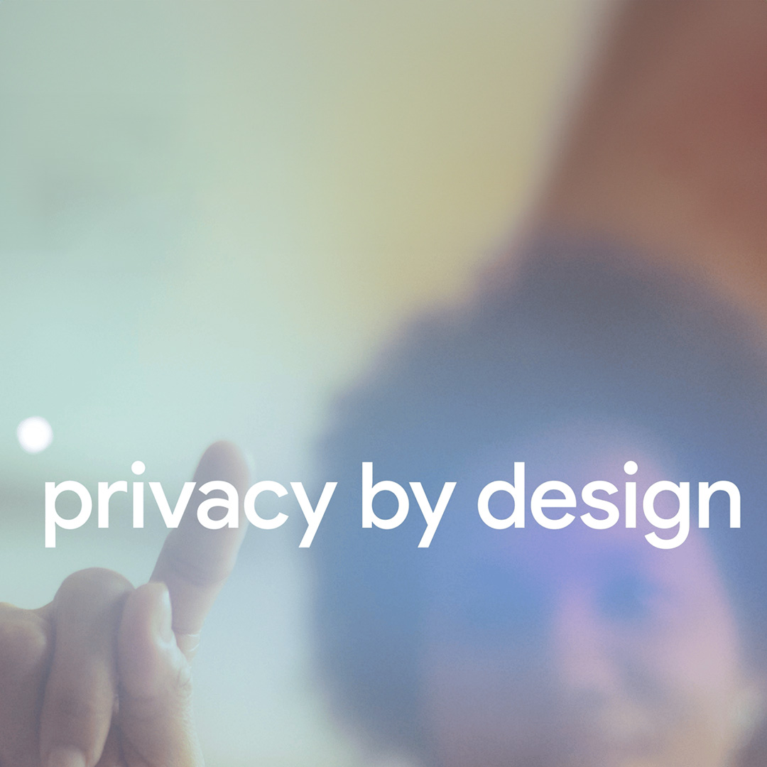 An out-of-focus image of a woman tapping a screen with the words: privacy by design