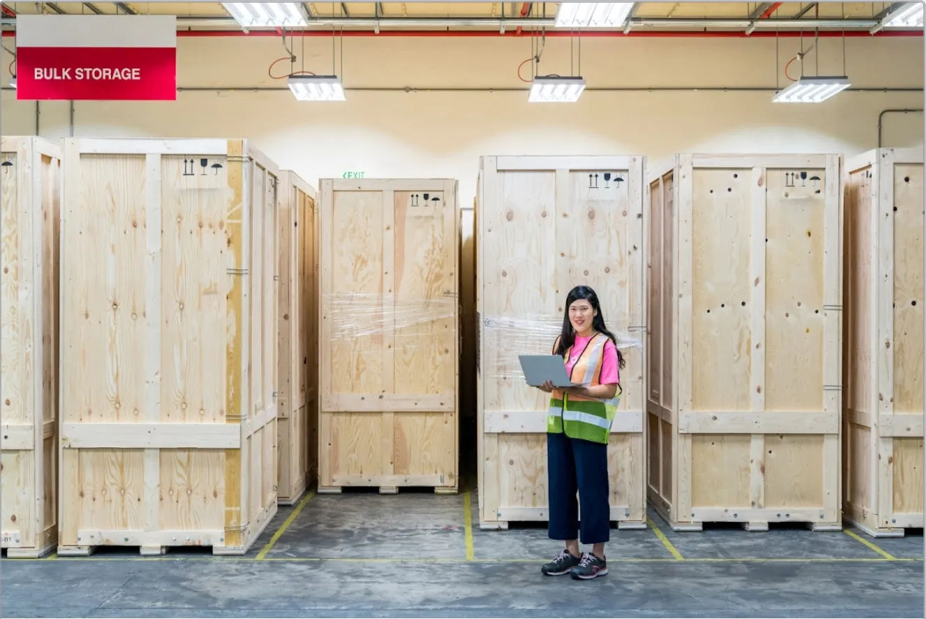 A Google employee standing in front of a wall of computer parts.