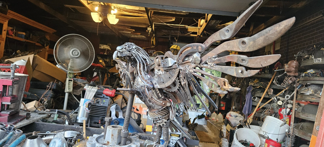 A collage of two photos of a metalwork sculpture of an eagle. The first image of the eagle is in a garage, in the background there are recycled materials. The second image shows the eagle outdoors, showcasing materials. 